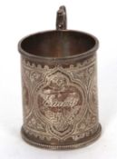 A late Victorian silver christening mug having a cast handle, beaded border and flower and leaf
