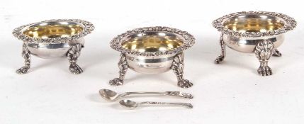 Three Georgian silver cauldron salt cellars having plain bodies with cast border of shells,