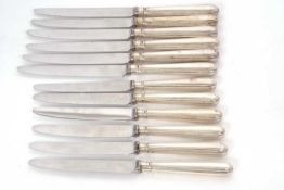Six silver handled table knives, six silver handled dessert knives, the handles hallmarked for