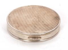 A hallmarked silver ladies compact of circular form, engine turned decorated lid with plain sides,