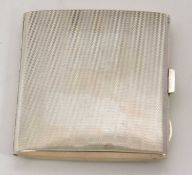 An Art Deco silver cigarette case of rectangular form, engine turned decorated with push button
