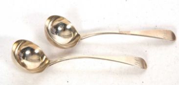 A pair of George III Old English pattern silver sauce ladles having circular bowls and initialled