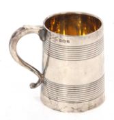 A George V small silver tankard of tapering cylindrical form having reeded decoration with initals