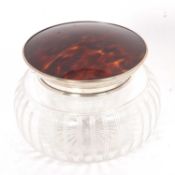 A George V glass powder bowl with silver and tortoiseshell pull off lid, Birmingham 1921, makers