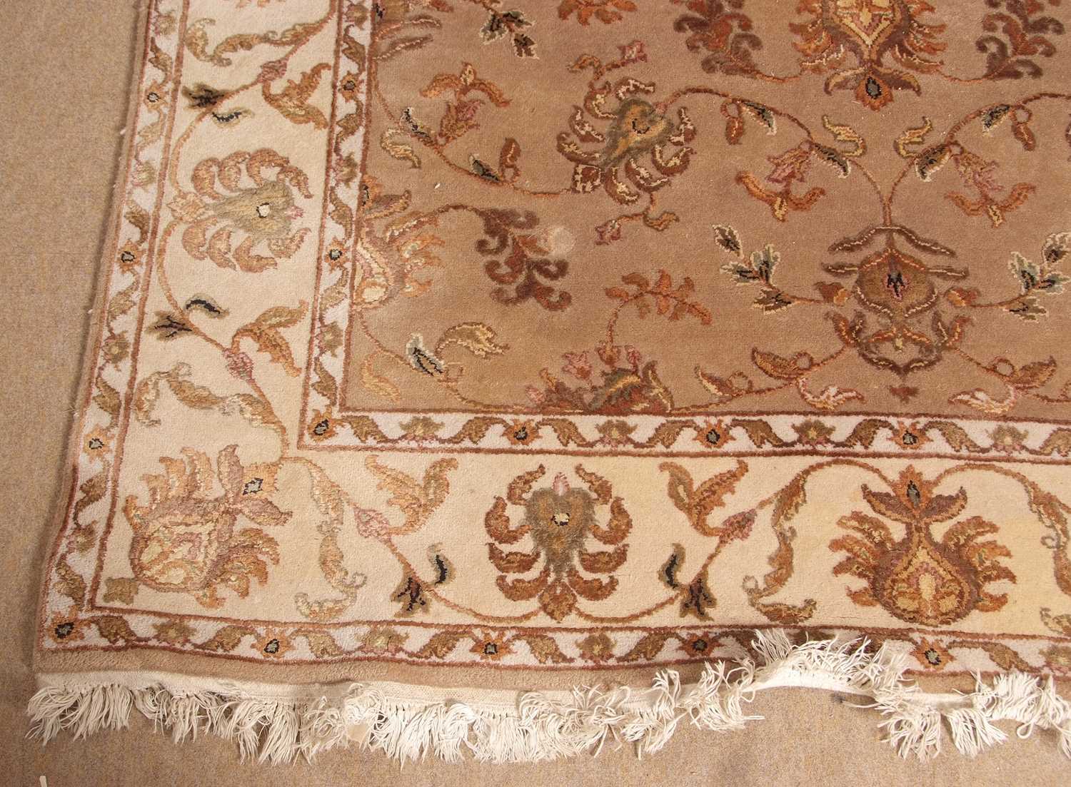 A 20th Century wool floor rug decorated with a stylised floral design on a cream and taupe - Image 2 of 16