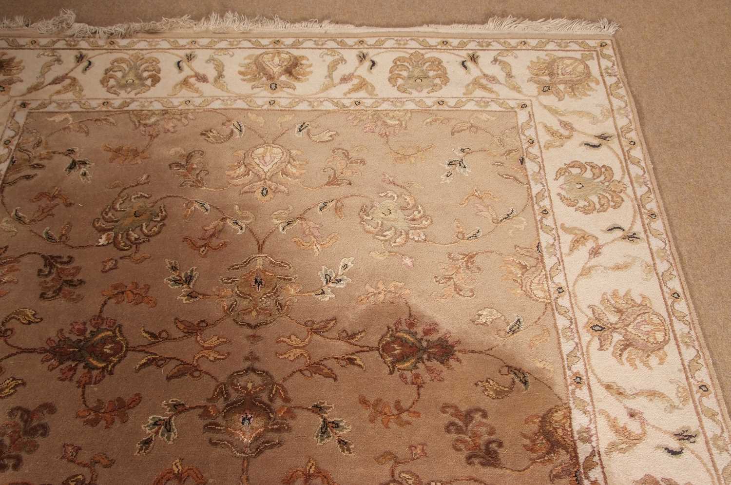 A 20th Century wool floor rug decorated with a stylised floral design on a cream and taupe - Image 12 of 16