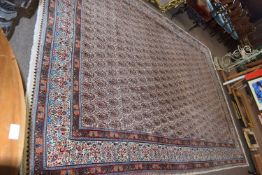 Modern Iranian wool floor rug set with a large central floral panel on a pale background