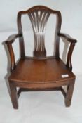 A small Georgian mahogany child's chair with hard seat and pierced splat back, 60cm high