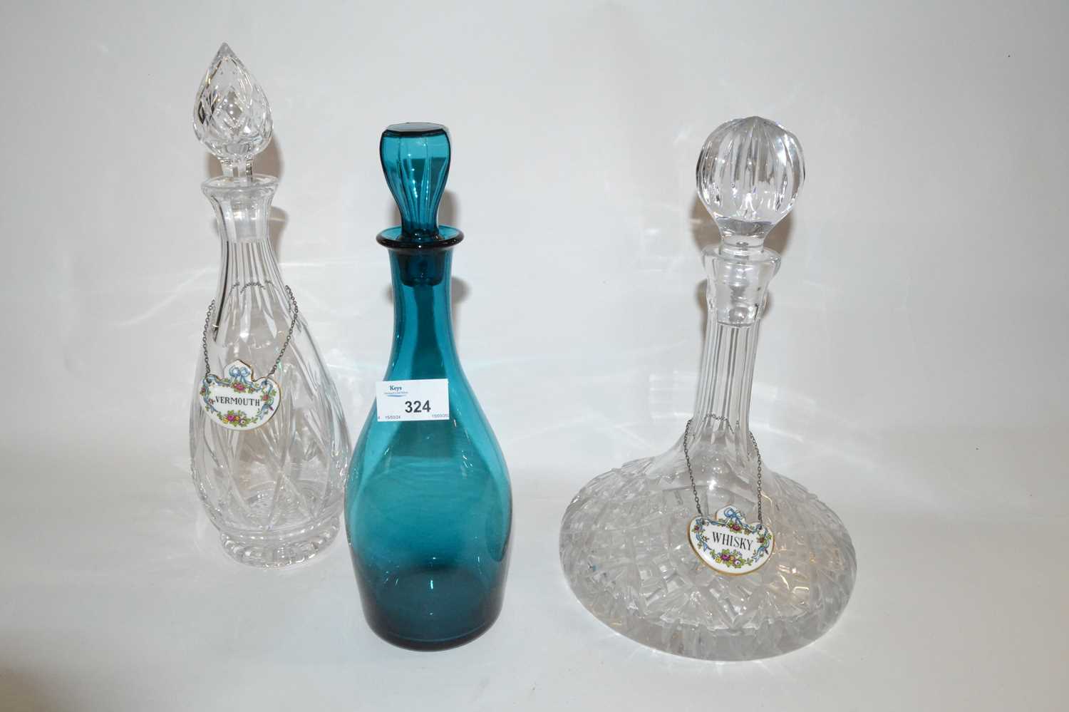 Group of three decanters, two cut glass further Bristol green glass decanter, the cut glass