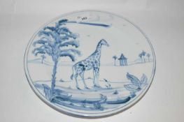 An Isis Ceramics dish made for Colefax & Fowler decorated in Delft style with a giraffe, 27cm