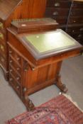 A late Victorian mahogany Davenport desk of typical form with brass galleried top, green leather