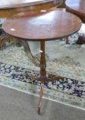 Georgian mahogany wine table with circular top over a tapering column and tripod base, 72cm high