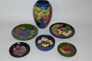 A group of Moorcroft wares including a vase decorated with Anemones, small pin dish with Hibiscus on