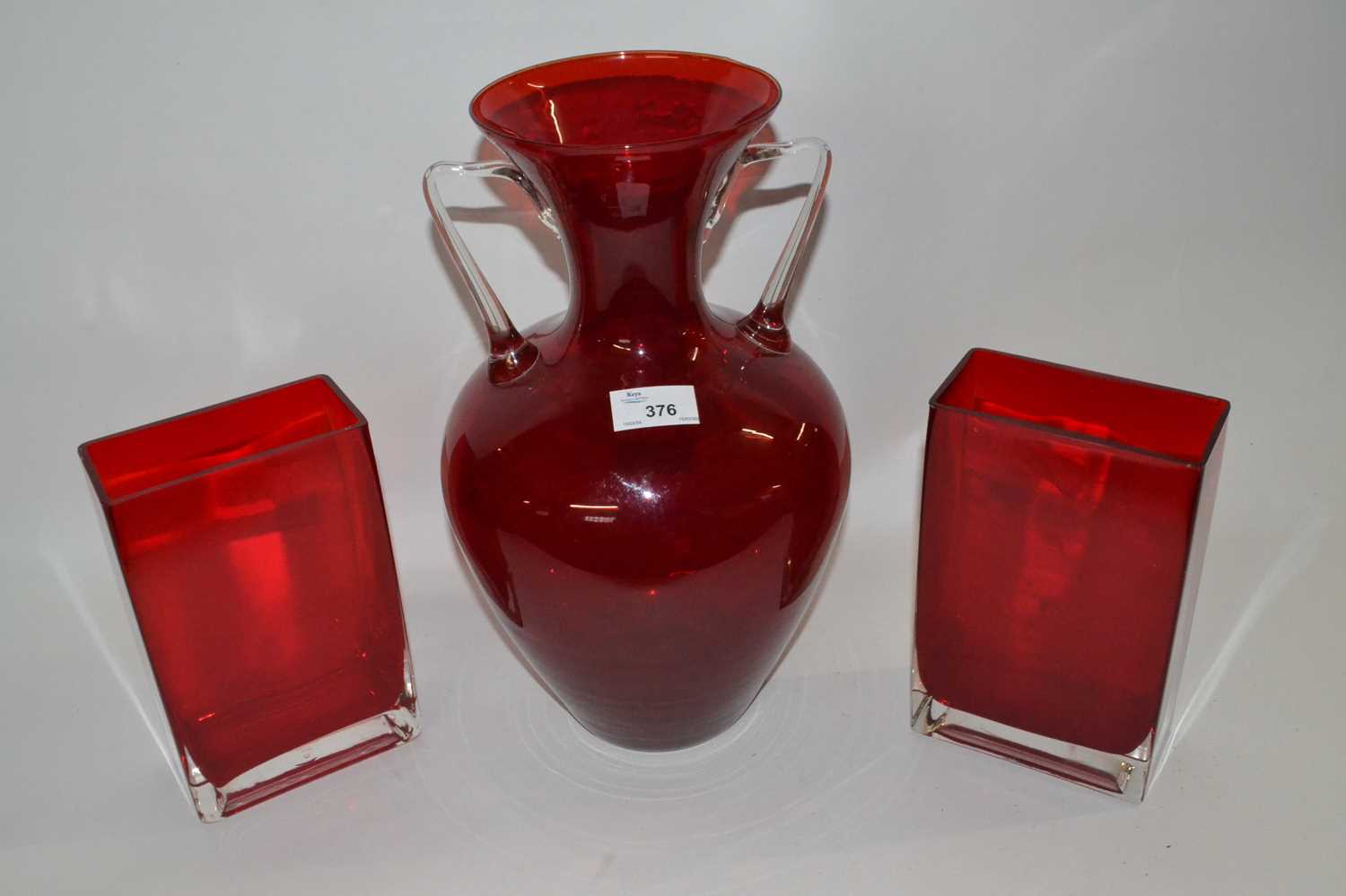 A pair of ruby coloured Art Glass vases of rectangular form together with a further large ruby