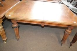 A Victorian faded oak extending dining table on fluted legs, 136cm wide