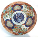 A large Japanese porcelain charger Meiji period decorated in Imari style with panels of birds,