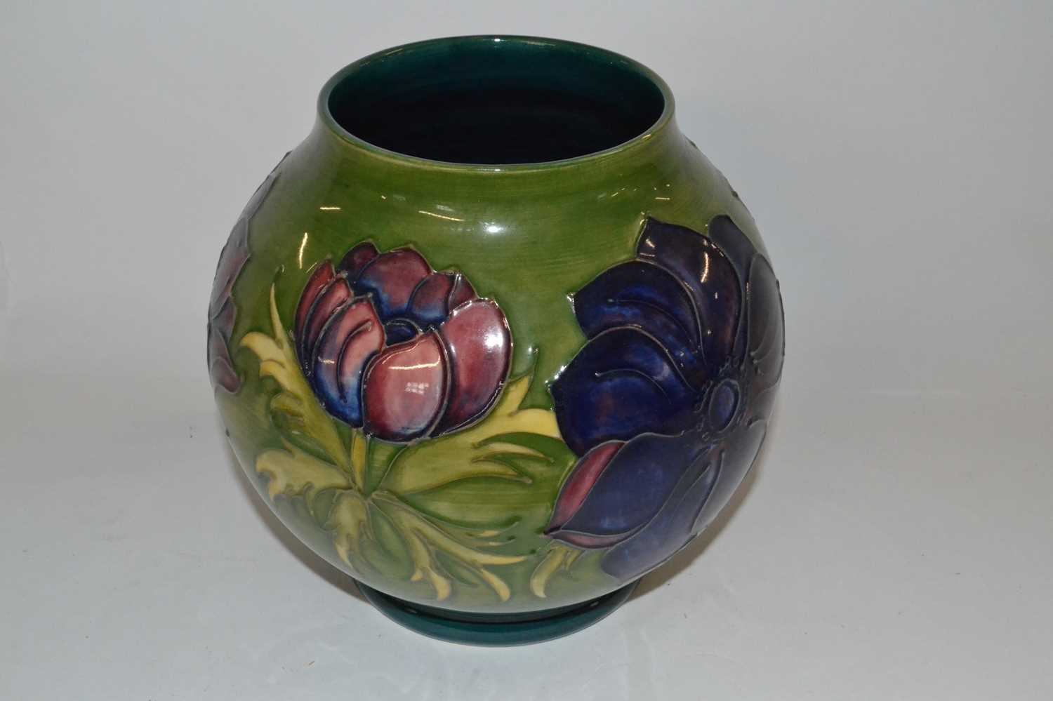 A Moorcroft vase of globular form, the green ground with tubelined Anemone design