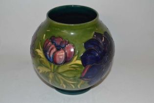 A Moorcroft vase of globular form, the green ground with tubelined Anemone design