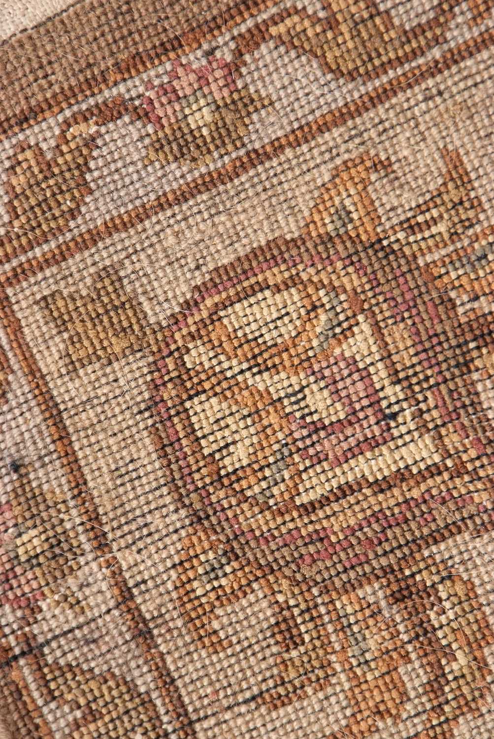 A 20th Century wool floor rug decorated with a stylised floral design on a cream and taupe - Image 6 of 16