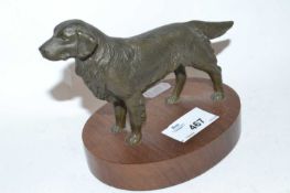 A bronzed model of a retriever on oval wooden base