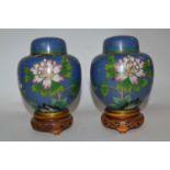 A pair of Cloisonne jars and covers, the blue ground with floral decoration, covers with matching