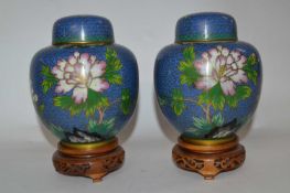 A pair of Cloisonne jars and covers, the blue ground with floral decoration, covers with matching