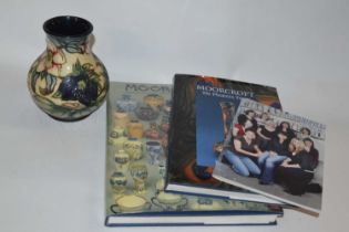 Moorcroft vase in the Hellebore pattern together with Moorcroft books including Moorcroft by Paul