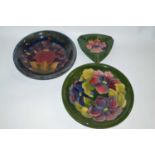 A group of Moorcroft wares including a Pomegranate pattern dish, further dish with Anemone pattern