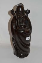 A Chinese carved hardwood figure of Shoulai carrying the peach of immortality, 40cm tall, probably