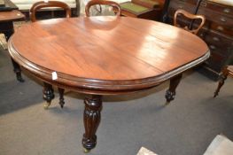 A Victorian oval mahogany extending dining table on fluted legs, lacking one caster, 165cm wide
