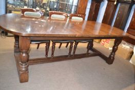 Contemporary oak refectory style dining table raised on turned legs with an H formed stretcher,