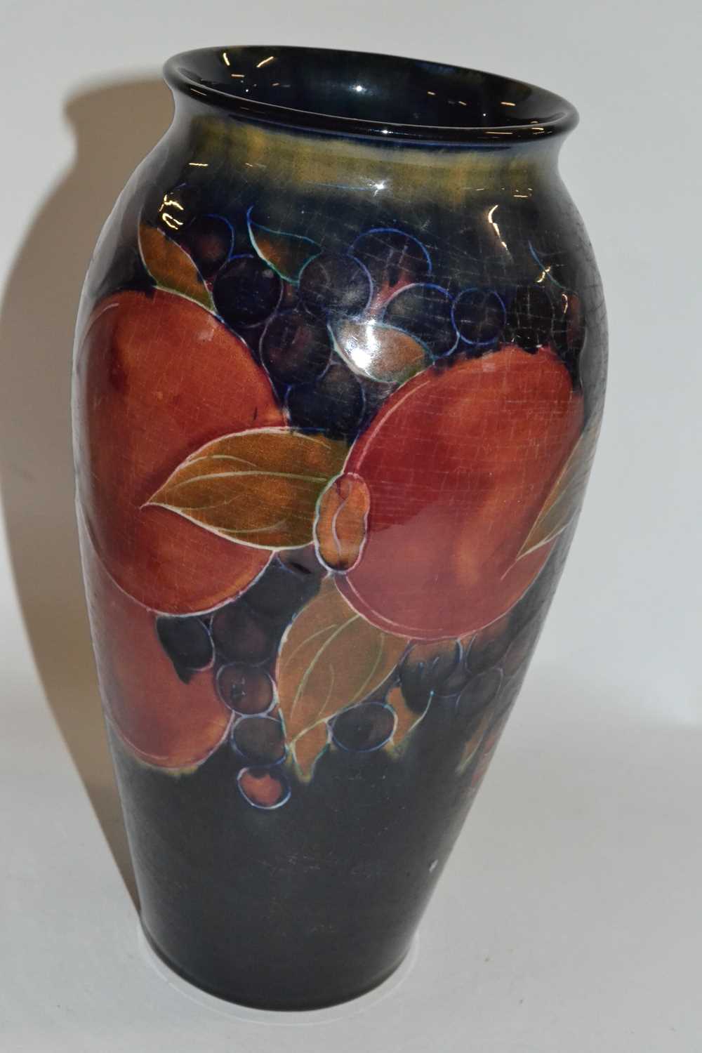 Moorcroft vase, the blue ground tubelined with the Pomegranate pattern, 27cm high Burslem mark,