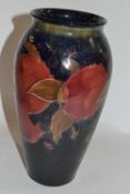 Moorcroft vase, the blue ground tubelined with the Pomegranate pattern, 27cm high Burslem mark,