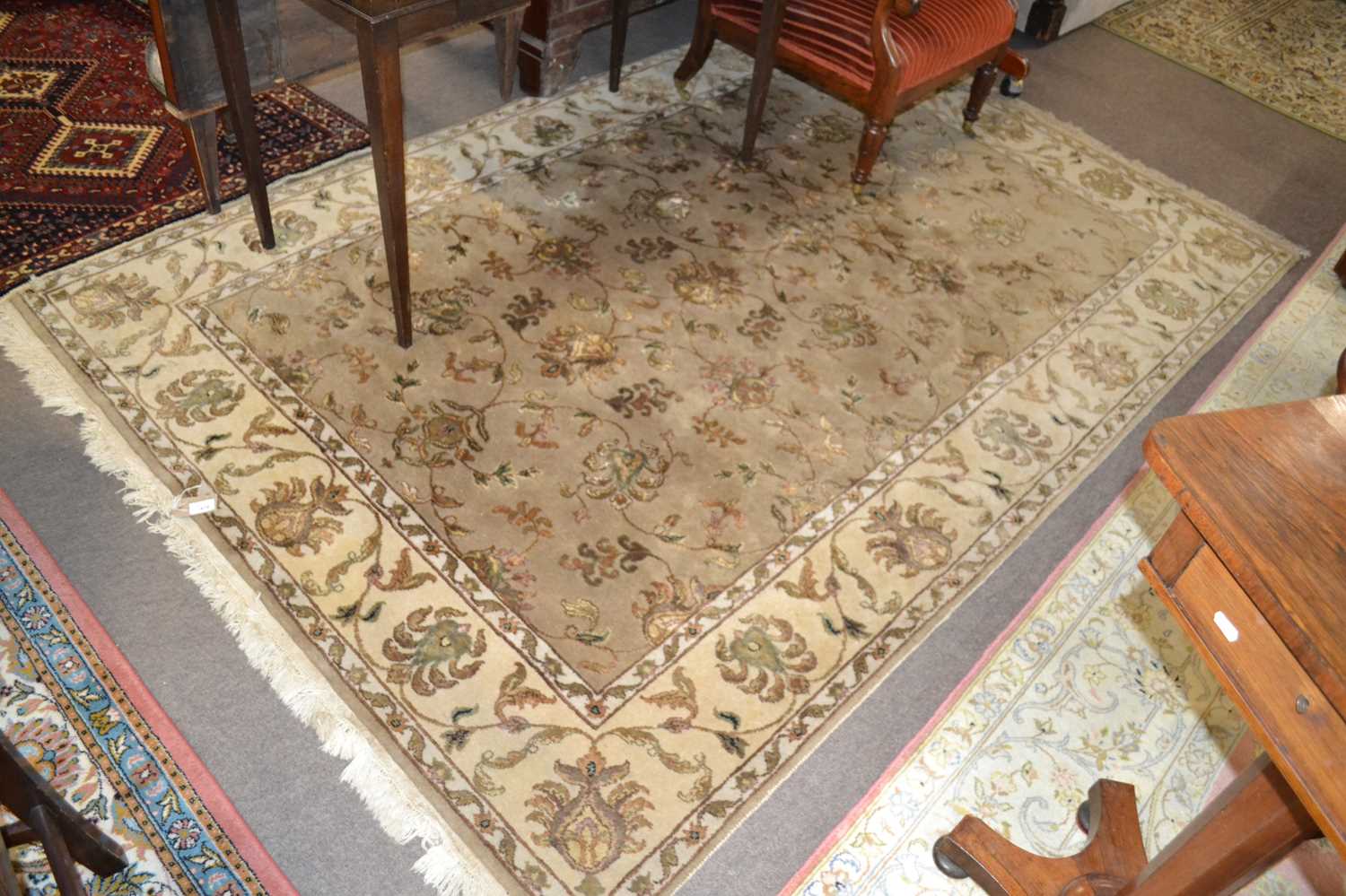 A 20th Century wool floor rug decorated with a stylised floral design on a cream and taupe - Image 9 of 16