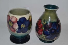 Two Moorcroft vases, one of baluster form, the green ground with tubelined anemone pattern