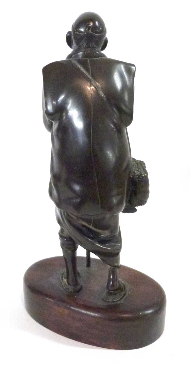 A bronze model of an Oriental, probably Japanese on oval wooden base, 18cm high - Image 3 of 3