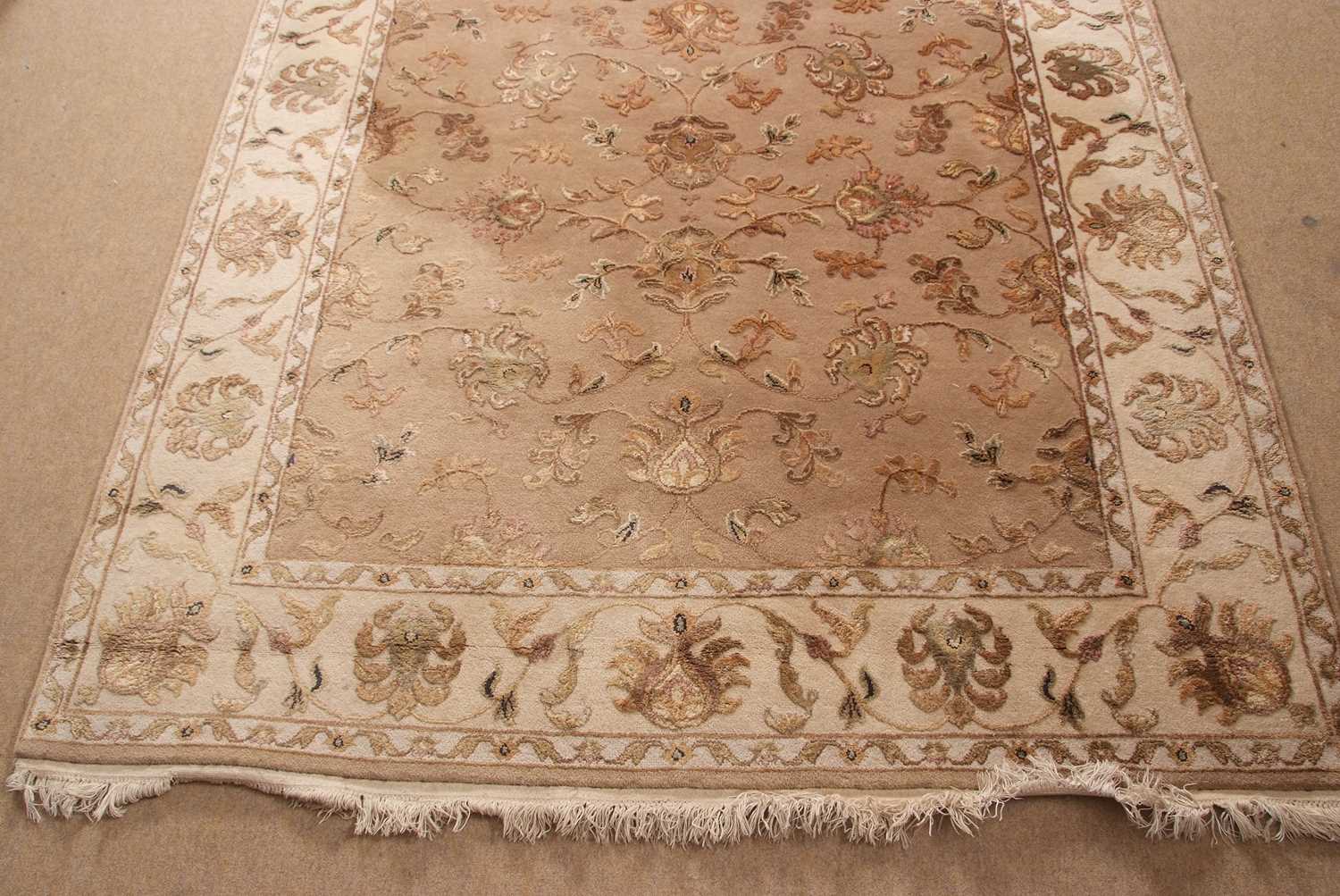 A 20th Century wool floor rug decorated with a stylised floral design on a cream and taupe - Image 8 of 16