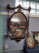 19th Century gilt and ebonised girandole type wall mirror with oval central mirror plate