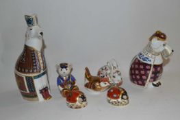 A Royal Crown Derby group of paperweights including gold stopper, model of a bear, silver stopper