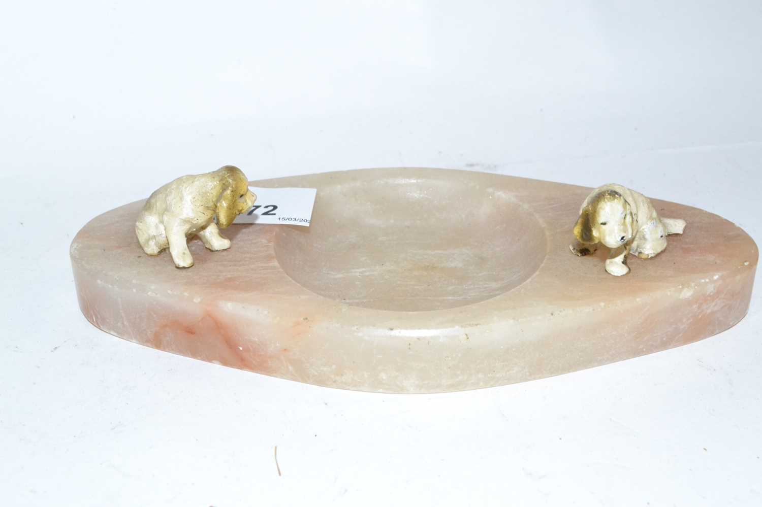 An onyx ashtray mounted with two painted dogs