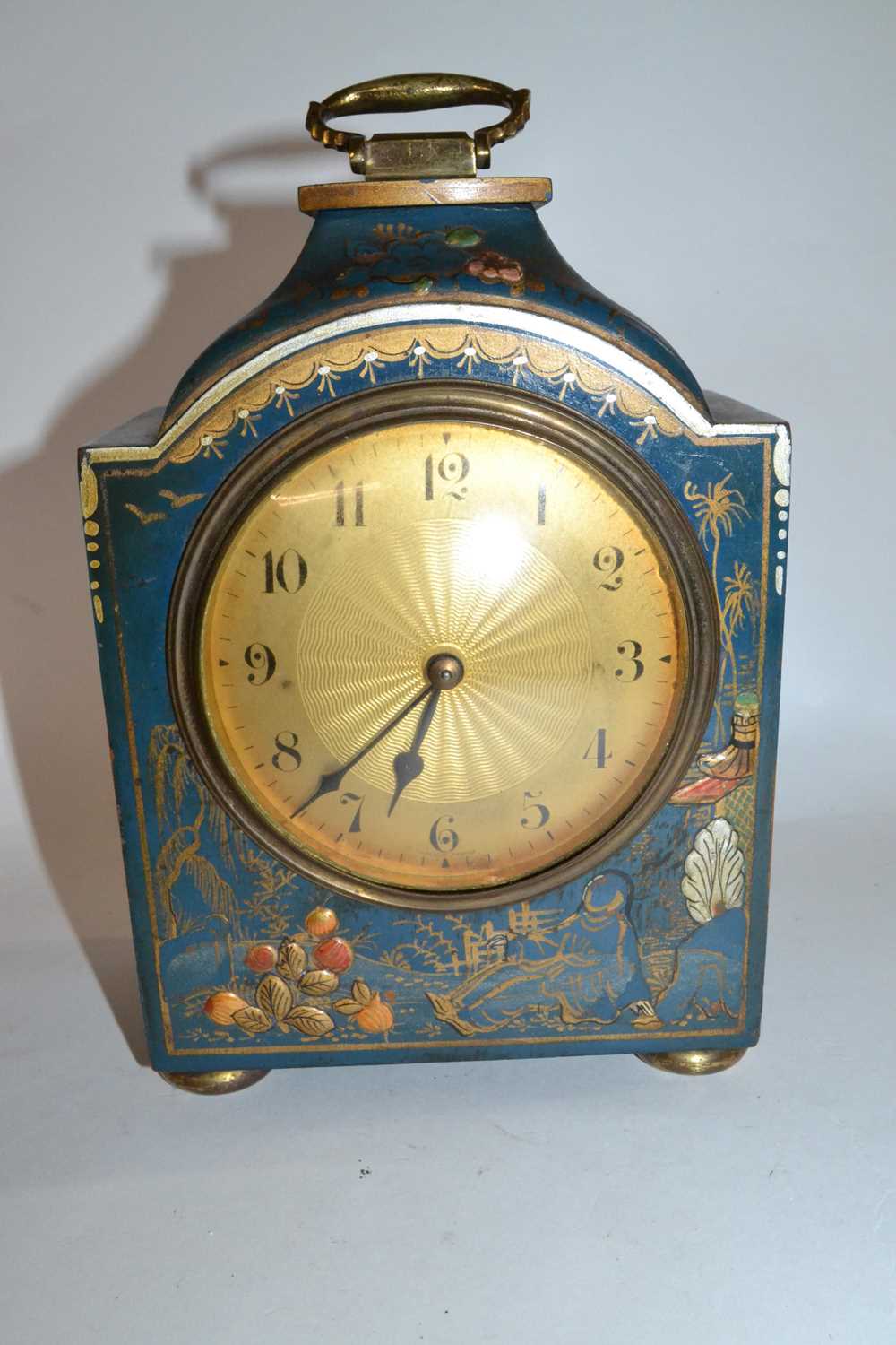 An early 20th Century mantel clock, the case with applied fruit decoration and Chinoiserie