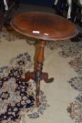 A Victorian mahogany wine table with circular top over a turned column and tripod base, 72cm high