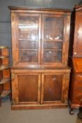 Victorian walnut veneered bookcase cabinet with moulded cornice over two glazed doors and two