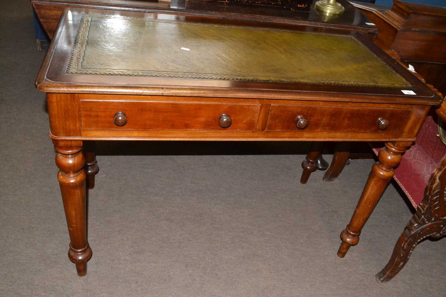 Victorian mahogany writing table with green leather inset top over two drawers and raised on