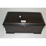 A small late 19th Century music box with 16" barrel set in an ebonised case, 34cm wide two teeth
