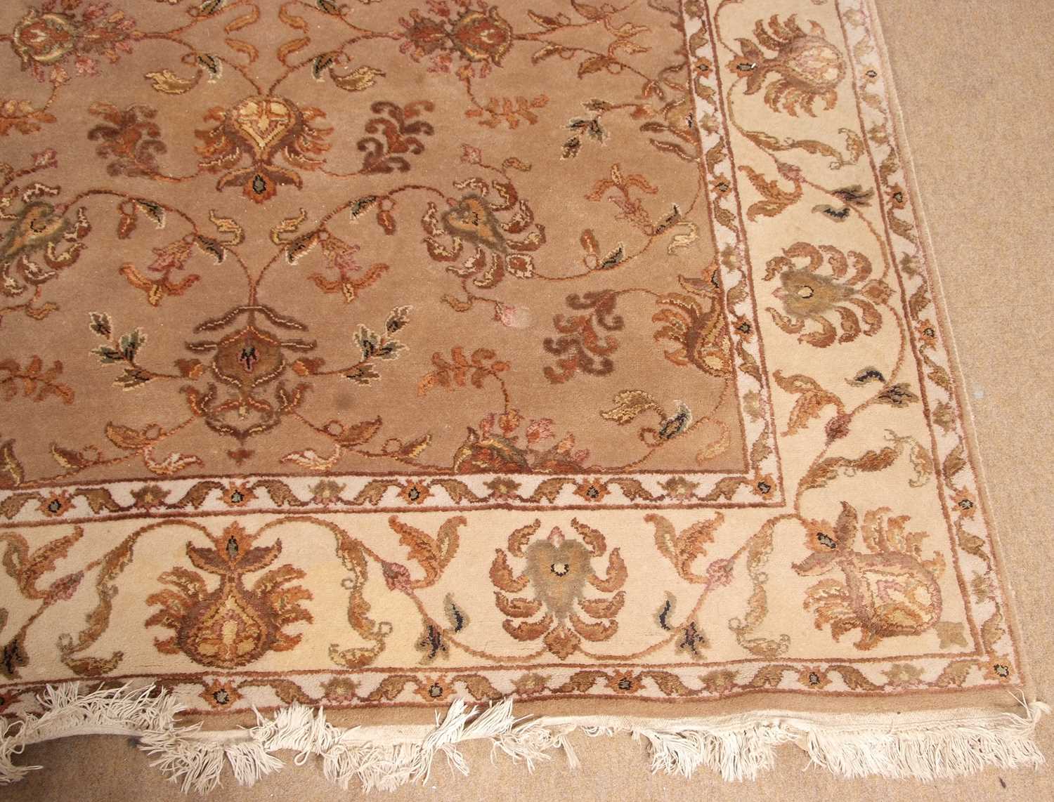 A 20th Century wool floor rug decorated with a stylised floral design on a cream and taupe - Image 3 of 16