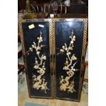 A pair of contemporary Oriental black lacquered panels decorated with foliage, 20cm high