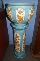 A Burmantofts jardiniere and stand, both pieces with floral decoration within light blue panels