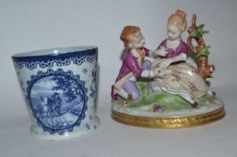 A Delft type vase with blue and white design and a continental German porcelain group of children