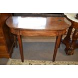 A Georgian mahogany D shaped side or hall table raised on tapering square legs, 105cm wide